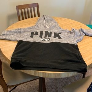 It’s a sweater, shirt, gray, and black with the words pink on it black